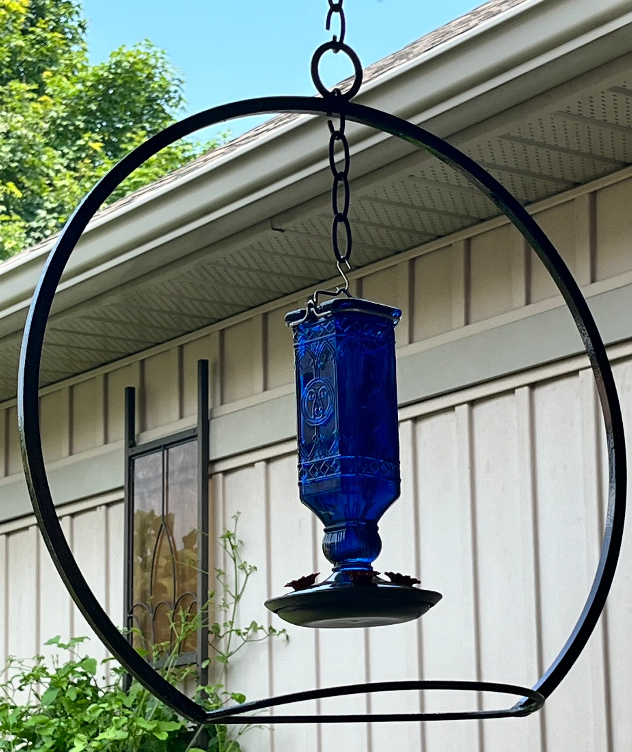 A real photo of  Perky-Pet® Cobalt Blue Square Antique Glass Bottle Hummingbird Feeder by Lucy (1)
